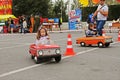 Children driving Soviet pedal cars `Moskvich` at the City Day in Volgograd