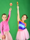 Children eat big colorful sweet caramels. Girls with happy faces Royalty Free Stock Photo