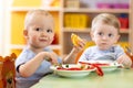 Children eat healthy food in nursery or creche