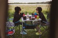 Children eating in front of the tent at a campsite