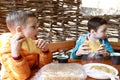 Children eating Khychin in restaurant