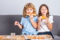 Children eating pizza. Little girl and boy eat pizza. Kids lunch. Royalty Free Stock Photo