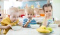 Children eating from plates in day care centre Royalty Free Stock Photo