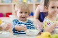 Children eating from plates in day care centre Royalty Free Stock Photo