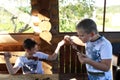 Children eating pork meat on skewers Royalty Free Stock Photo