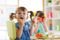 Children eating vegetables in kindergarten or at home