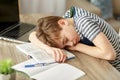 Tired student boy sleeping on desk at home Royalty Free Stock Photo