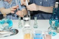 Children, elementary school boys, conduct chemical experiments with colored liquids in glass flasks, a scientific concept. 4k slow Royalty Free Stock Photo