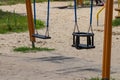 Children empty swing in the playground, close-up