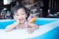 Children enjoy and have fun playing water in inflatable pool with colorful of small balls