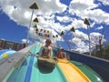 Children enjoy the slide in the amusement carnival