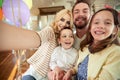 Children enjoy taking selfie at home with their parents. Family, leisure, together Royalty Free Stock Photo