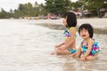 Children enjoy waves on beach