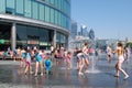 Children enjoying summer at a fountain in London