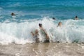 Children enjoying the wave splashes at the beach