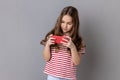 Little girl using mobile phone, kid playing video game on cellphone chatting in social network. Royalty Free Stock Photo