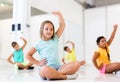 Group of children exercising during yoga class in fitness center - vakrasana pose Royalty Free Stock Photo