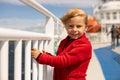 Children, experience ride on a ferry on a fjord, strong wind on the deck of a ferry on sunny day