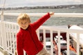 Children, experience ride on a ferry on a fjord, strong wind on the deck of a ferry on sunny day