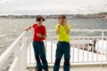 Children, experience ride on a ferry on a fjord, strong wind on the deck of a ferry on sunny day