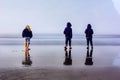 Children Explore Foggy Beach on Wet Sand Royalty Free Stock Photo