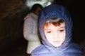 Children explore an underground cave with pile, adventurously