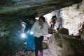 Children explore an underground cave with pile, adventurously