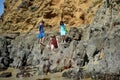 Children exploring rock formations at Crescent Bay in Laguna Beach, California.