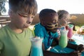 Children with face paint having drinks Royalty Free Stock Photo