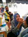 Children face painting. Artist painting little girl at the shop