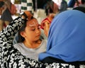 Children face painting. Artist painting little girl at the shop