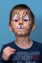 Children face painting. Boy painted as tiger or ferocious lion by make up artist. Preparing for theatrical performance. Boy actor Royalty Free Stock Photo