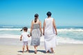 Children, family and beach with a girl, mother and grandmother enjoying the sea or ocean view while on vacation. Kids Royalty Free Stock Photo