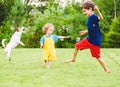 Children and family pet dog playing with funny soap bubbles on hot sunny summer day at backyard lawn Royalty Free Stock Photo