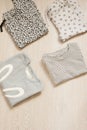 Children fashion clothes set for girl. Blouse, trousers and t-shirts on a gray wooden background