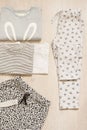 Children fashion clothes set for girl. Blouse, trousers and t-shirts on a gray wooden background