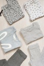 Children fashion clothes set for girl. Blouse, trousers and t-shirts on a gray wooden floor