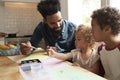 Children And Father Painting Picture On Kitchen Table Royalty Free Stock Photo