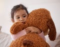 Children, fear and scary with a girl holding her teddy bear after a nightmare in her bedroom at home. Kids, anxiety and Royalty Free Stock Photo