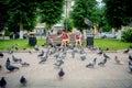 Children feed pigeons in Gusev, Russia