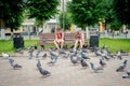 Children feed pigeons in Gusev, Russia