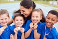 Children With Female Coach Showing Off Winners Medals On Sports Day Royalty Free Stock Photo