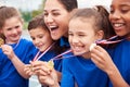 Children With Female Coach Showing Off Winners Medals On Sports Day Royalty Free Stock Photo