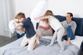 Children Fighting Pillows, Family Having Fun Bedroom, Parents With Daughter And Son Cheerful Together Royalty Free Stock Photo
