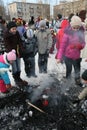 Children of the fire by the ashes after burning of effigies of the spirit of winter carnival at national public holiday.