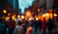 Children with fireworks stick. Holiday dynamic postcard. Happy children holding a lighted fireworks on a blurred background of a