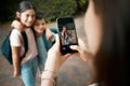 Children first day of school and mother taking photos with a phone of her cute kids. Closeup of screen picture of Royalty Free Stock Photo