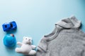 Children flat lay with clothes blue background top view space for text . baby blue car , duck , teddy, clothing Royalty Free Stock Photo