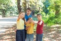 Children in the forest with a compass look and point their finge