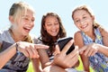 Children, friends and cellphone in park or laughing at funny post on social media for humor, online or joke. School kids Royalty Free Stock Photo